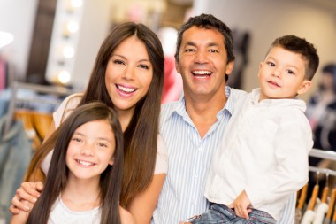 Family of four with bright smiles